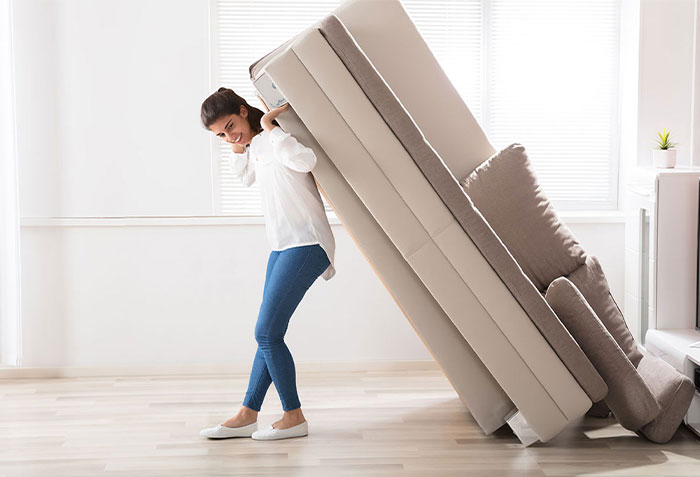 Woman moving sofa | California Renovation