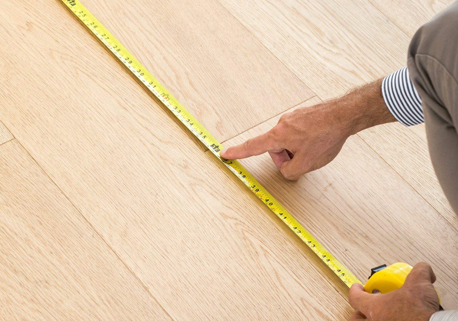 Man measuring floor | California Renovation